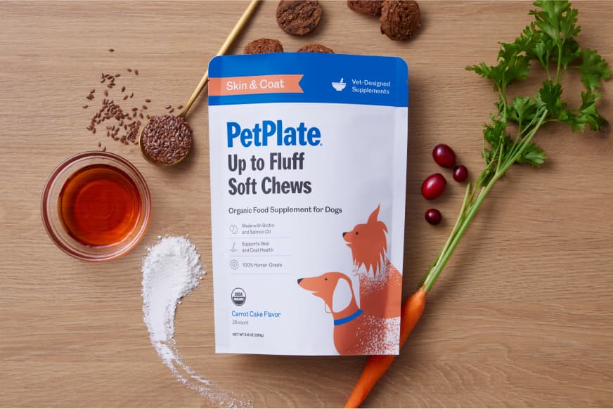 package of supplements surrounded by healthy ingredients